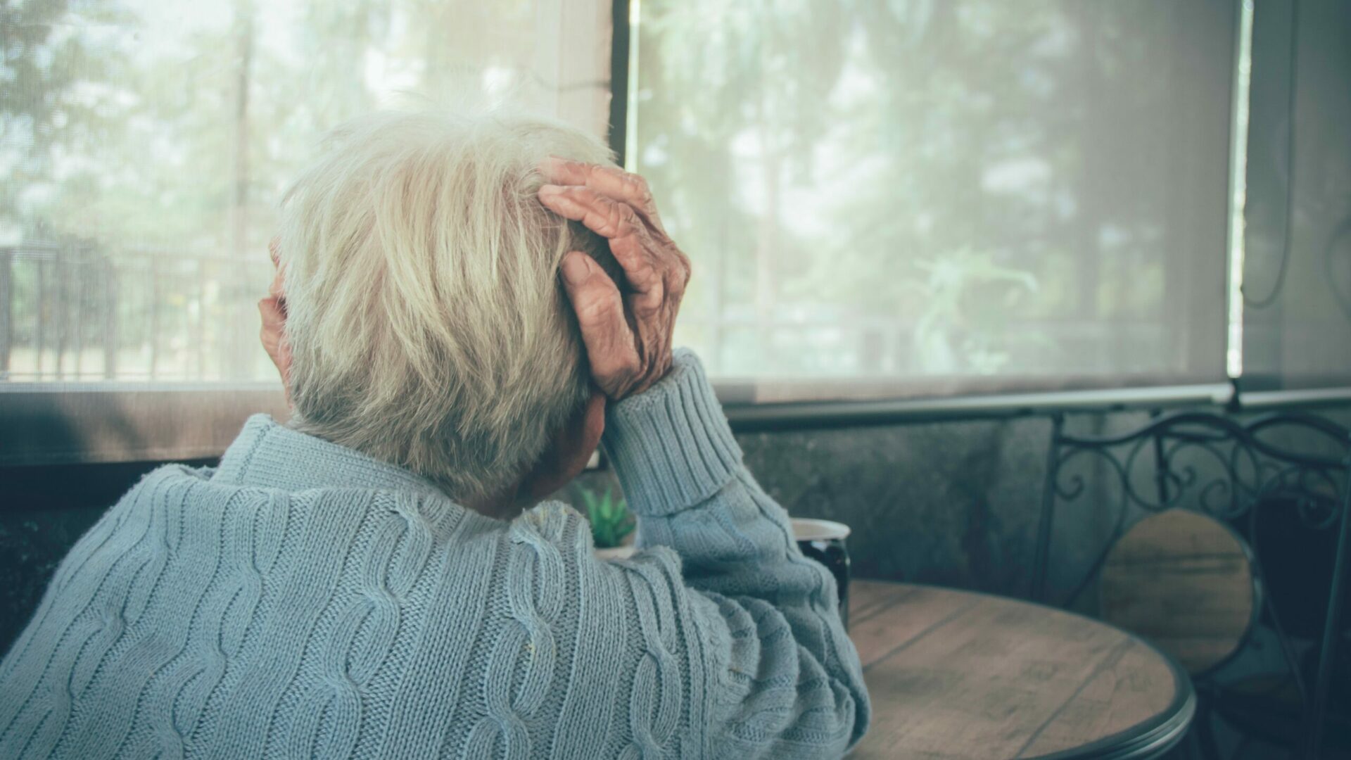 Oudere vrouw met hand in het haar